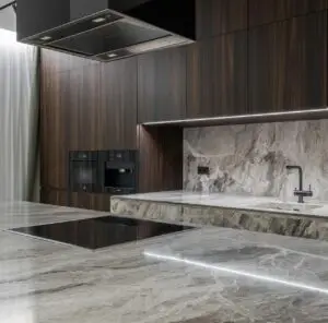 Interior design of spacious stylish modern kitchen with induction stove and air extraction system with wooden cupboards